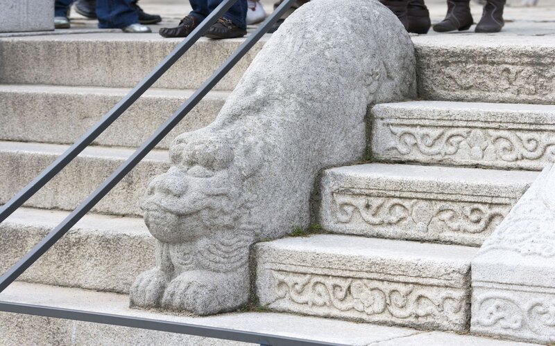 stone lion statue on stairs