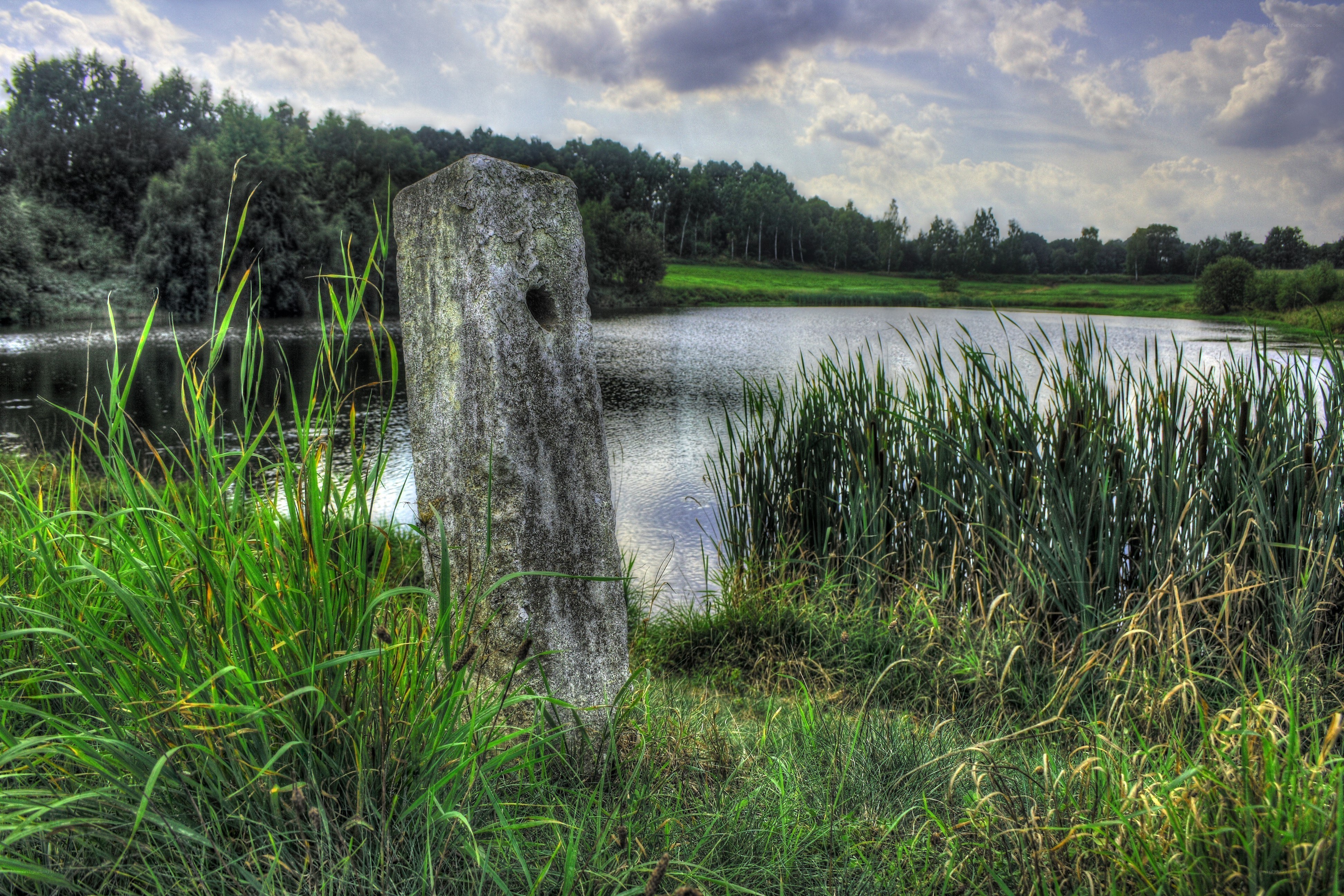 Stone marker by a lake