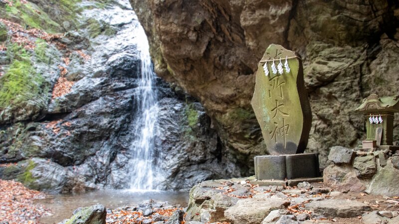 Stone Marker Near Waterfall
