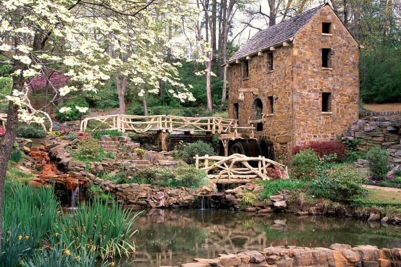 Stone mill by a garden pond