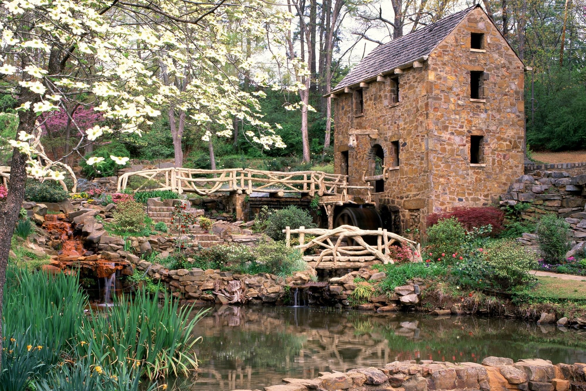 Stone mill by a garden pond