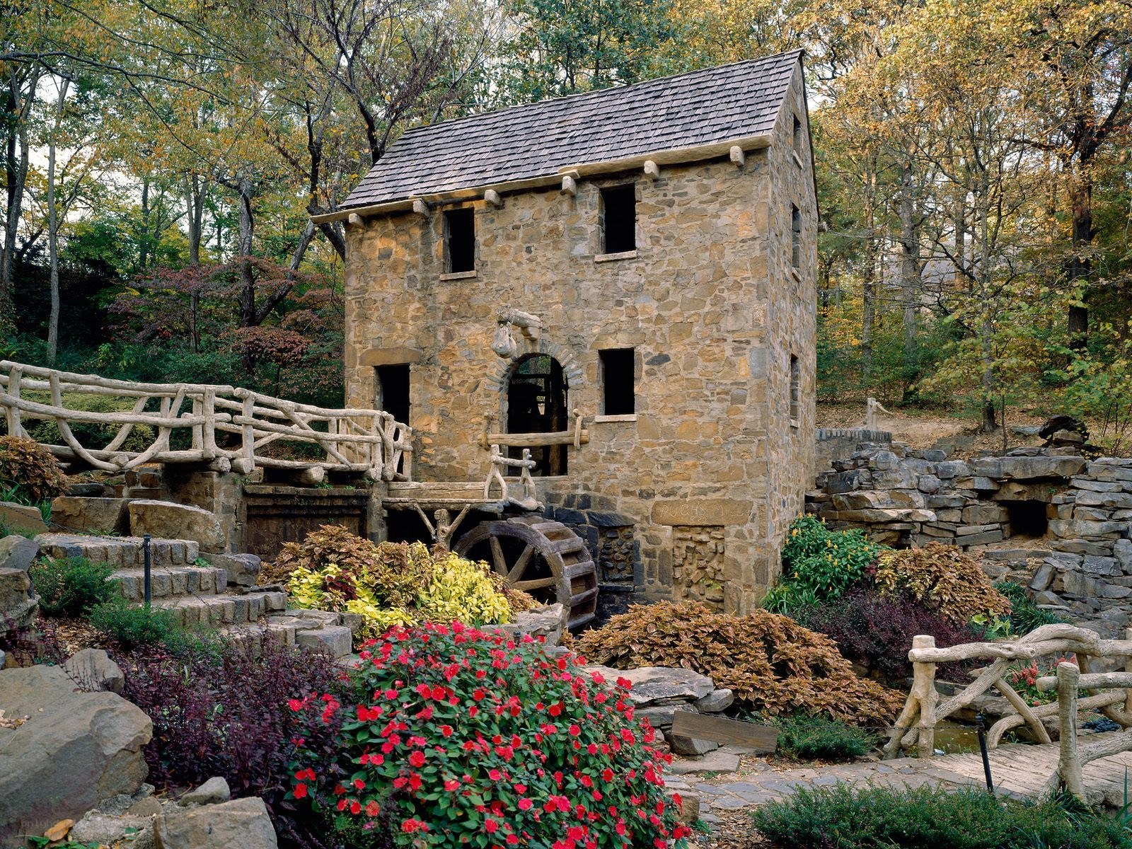Stone mill in autumn garden