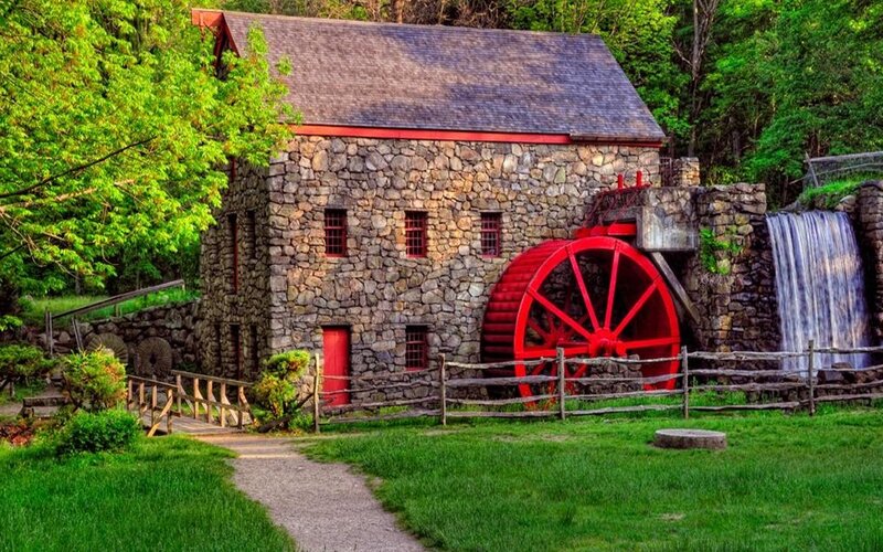 Stone mill with red waterwheel