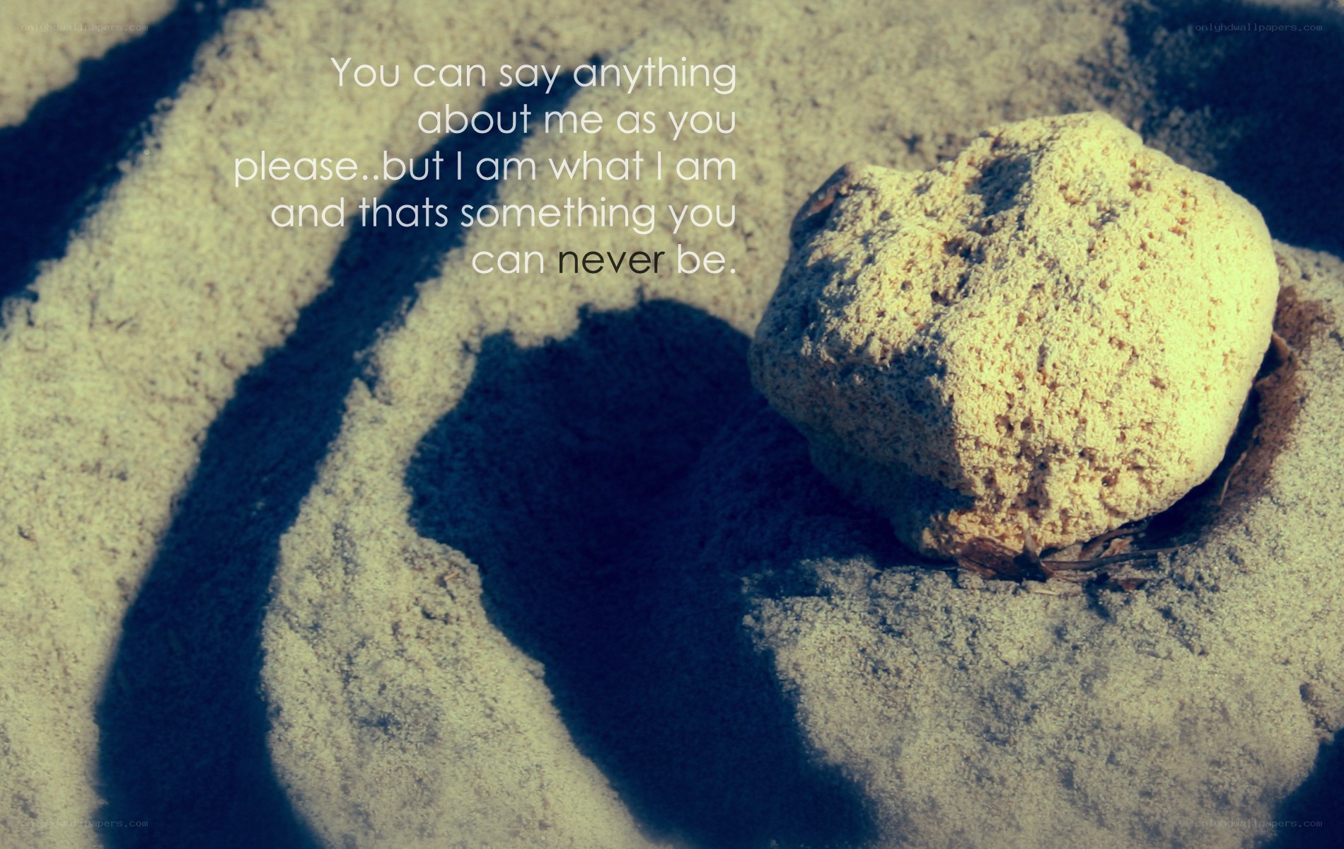 stone on sand with quote