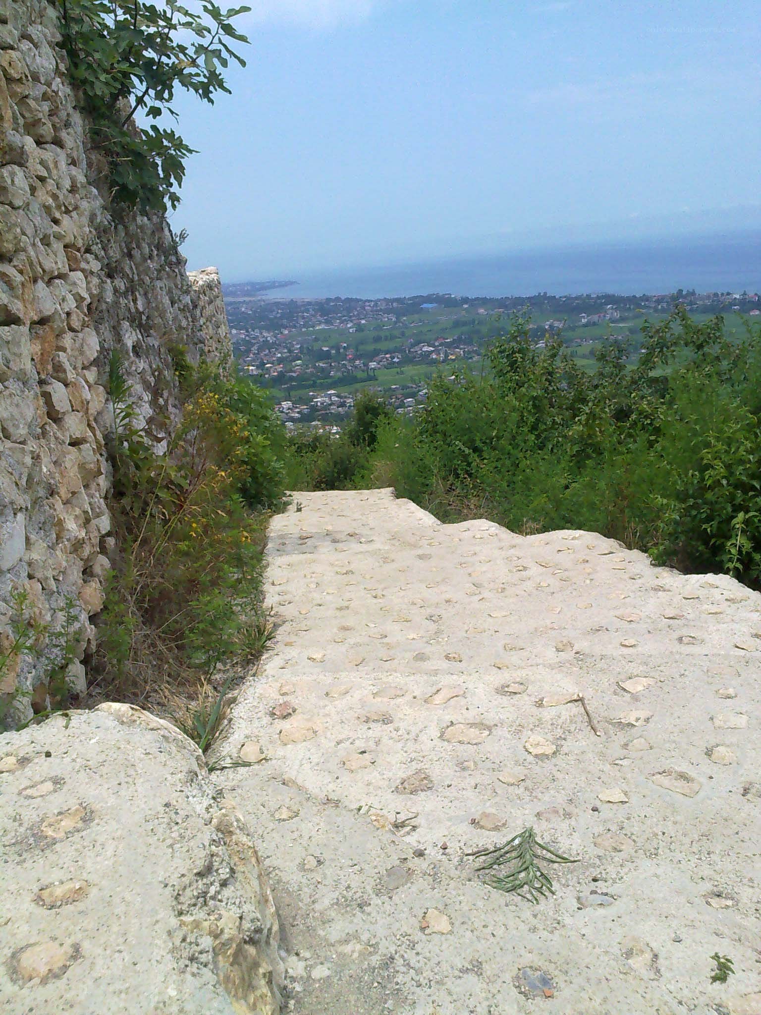 Stone path overlooking a coastal town
