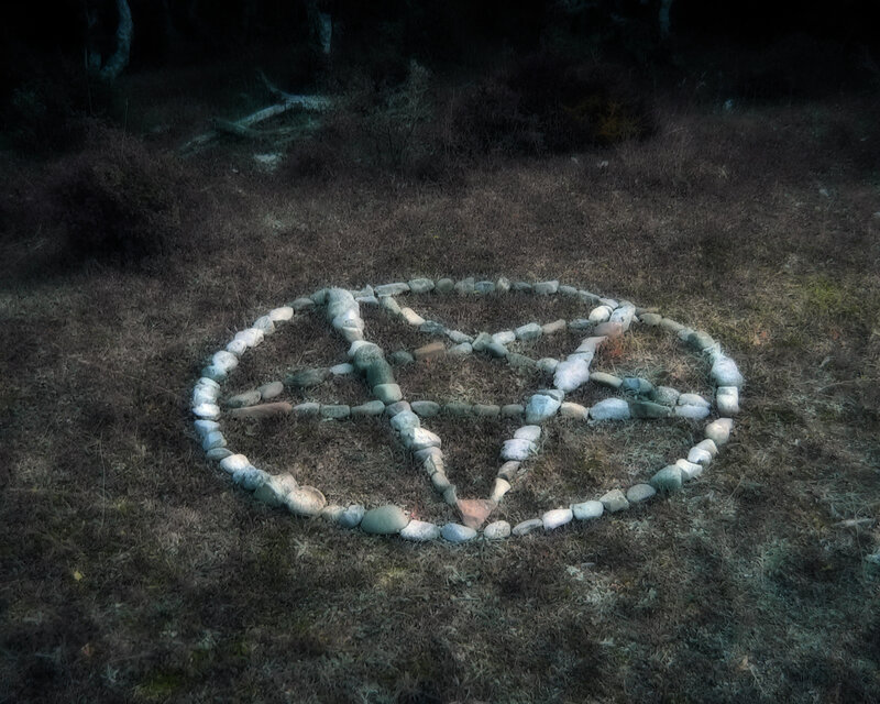 Stone pentagram in forest clearing
