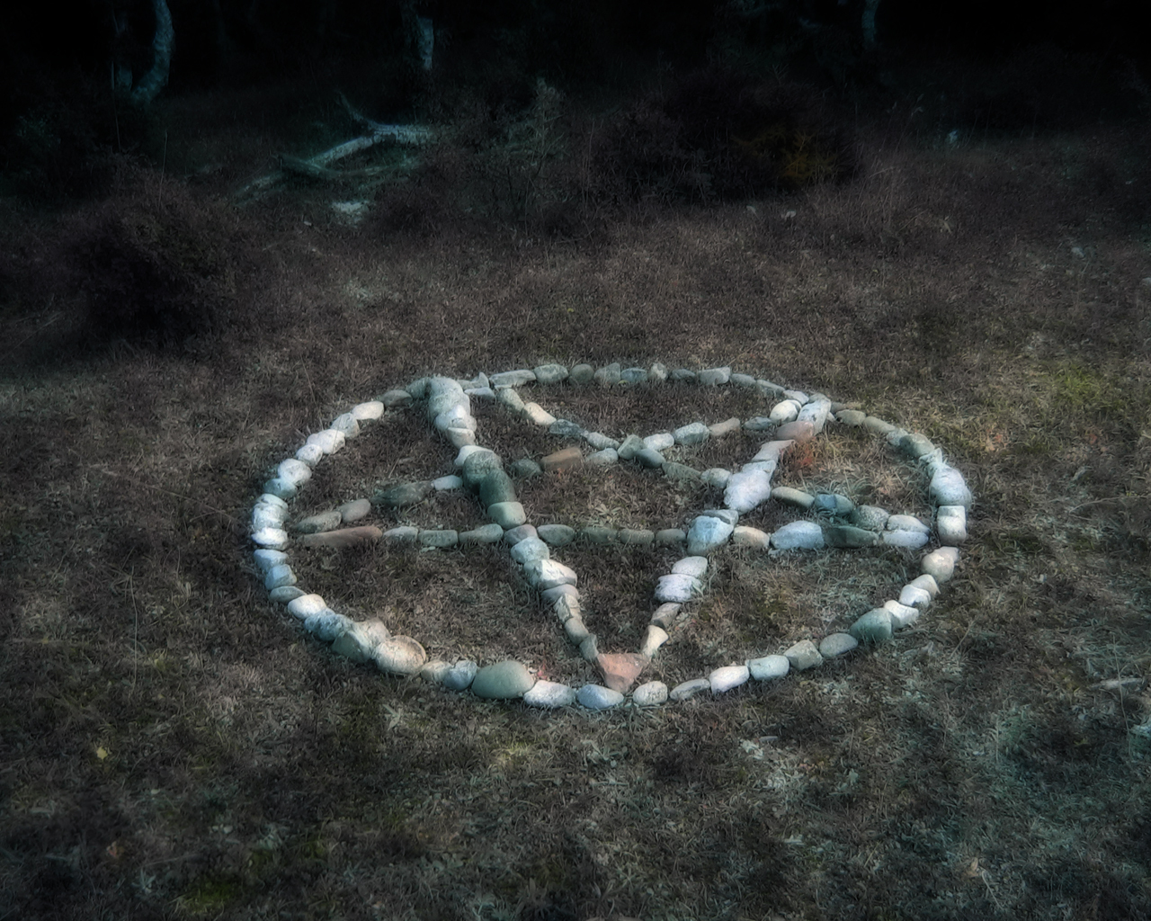 Stone pentagram in forest clearing