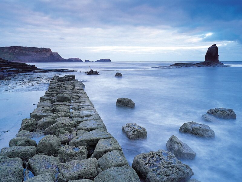 Stone pier at coastal inlet