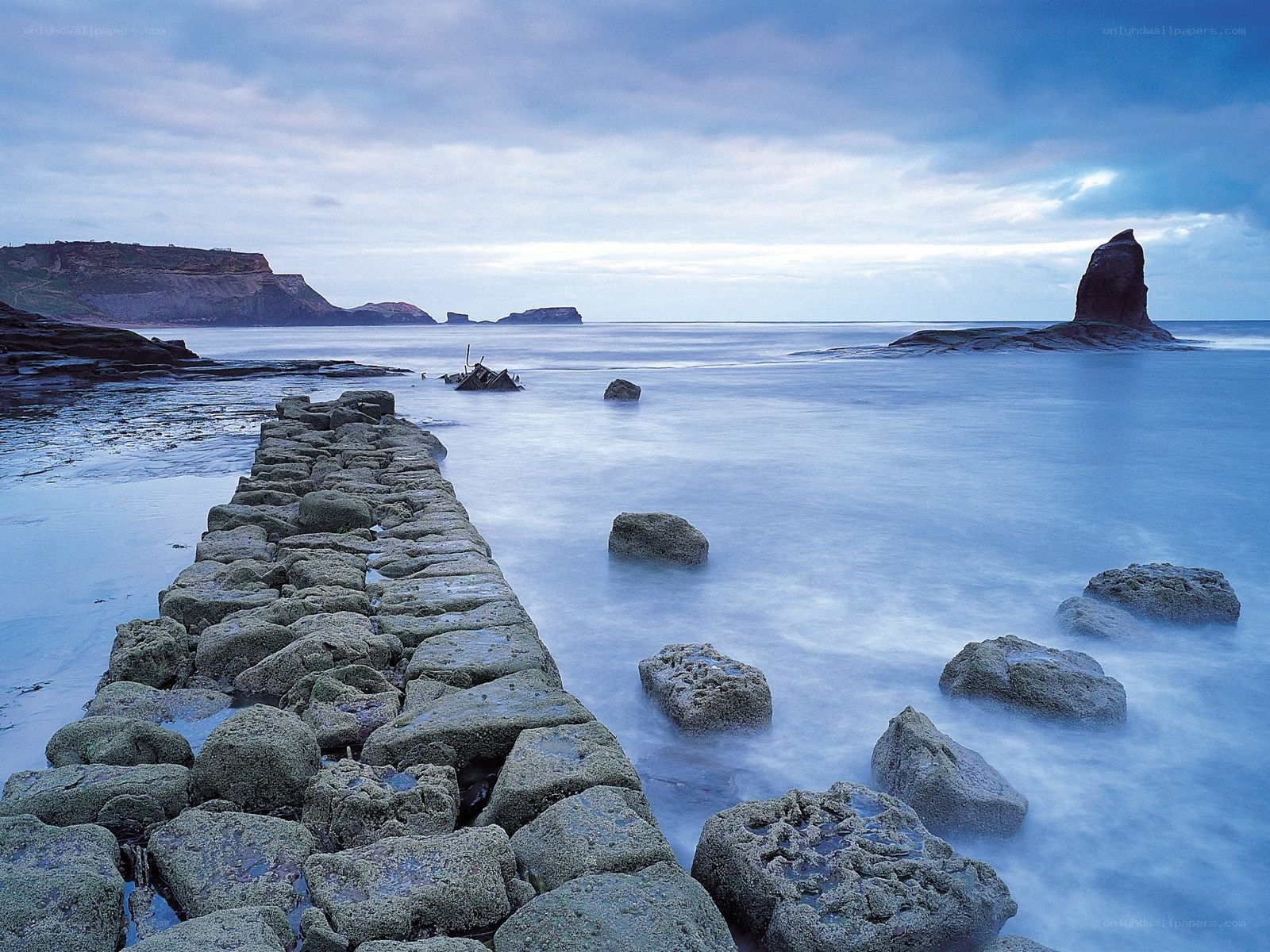 Stone pier at coastal inlet