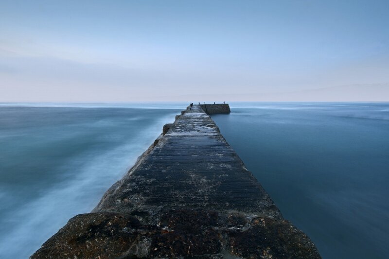 Stone Pier Extending into Sea — Blue