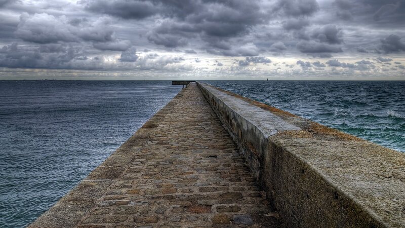Stone Pier Extending into Sea — Gray, Dramatic