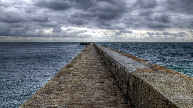 Stone Pier Extending into Sea — Gray