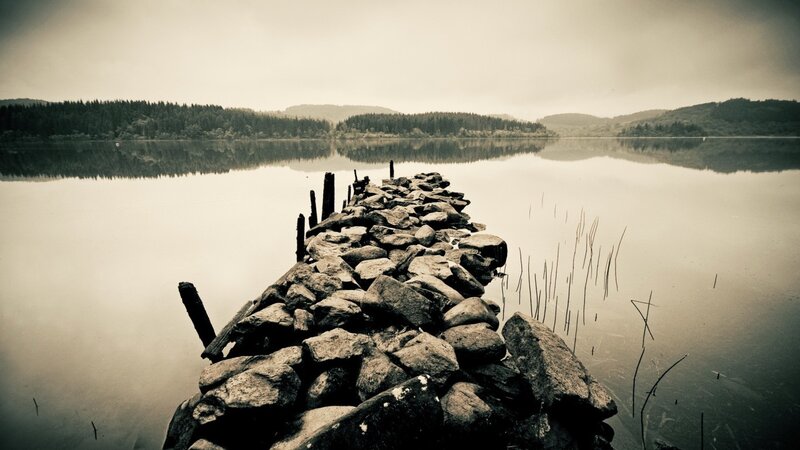 Stone pier on a calm lake