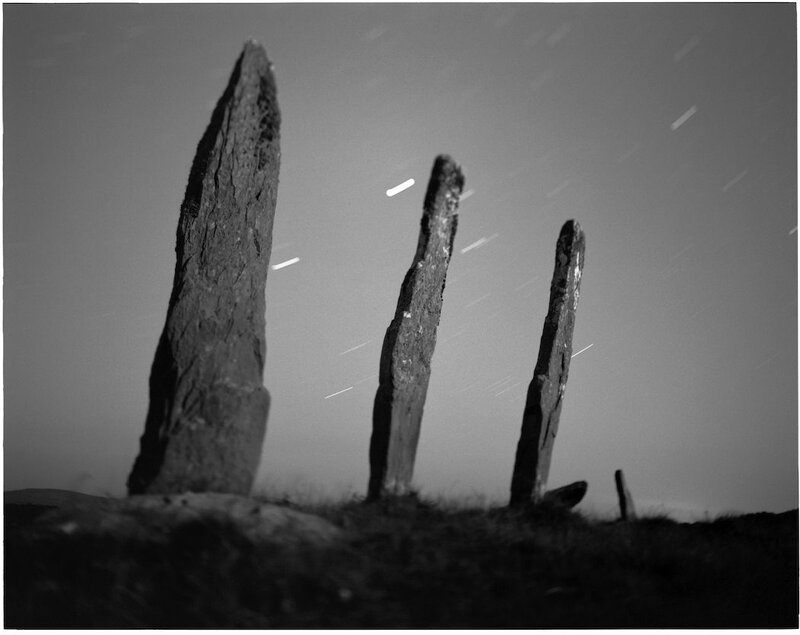 Stone pillars under star trails