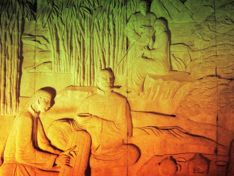 stone relief carving of tea ceremony