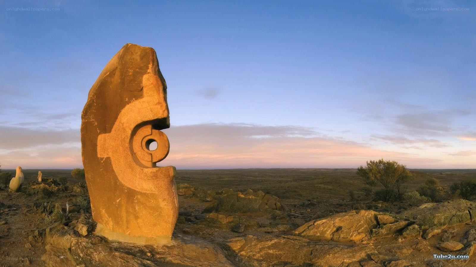 Stone sculpture in desert landscape