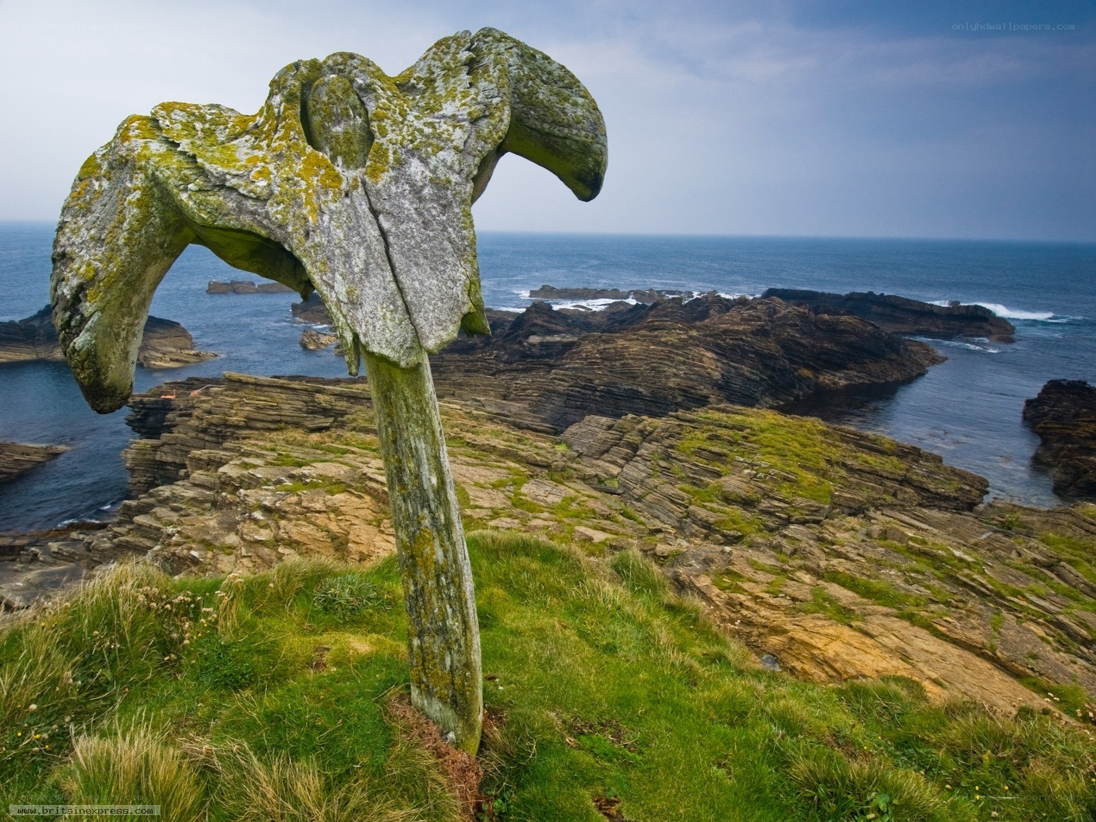 Stone sculpture on coastal cliff