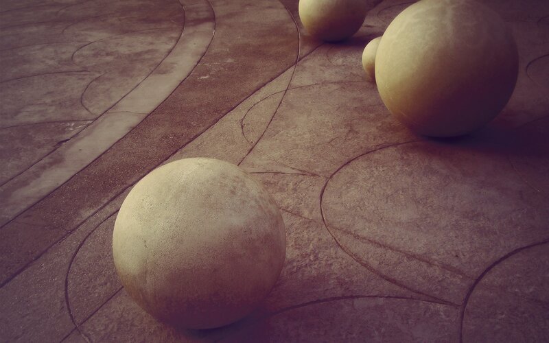 Stone spheres on patterned pavement