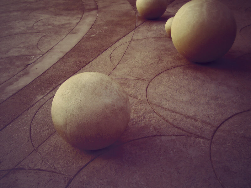 Stone spheres on patterned pavement