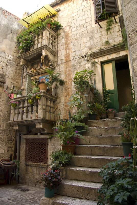 Stone staircase with balconies in old town