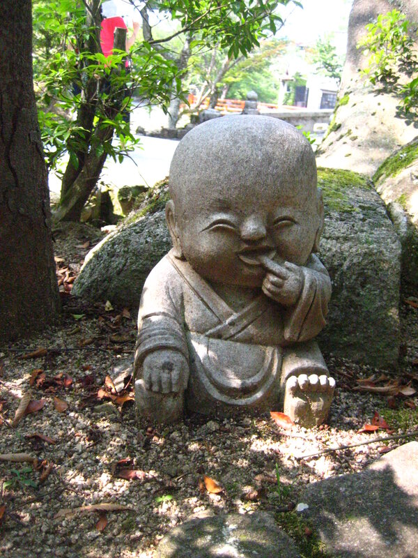 Stone statue of a laughing child