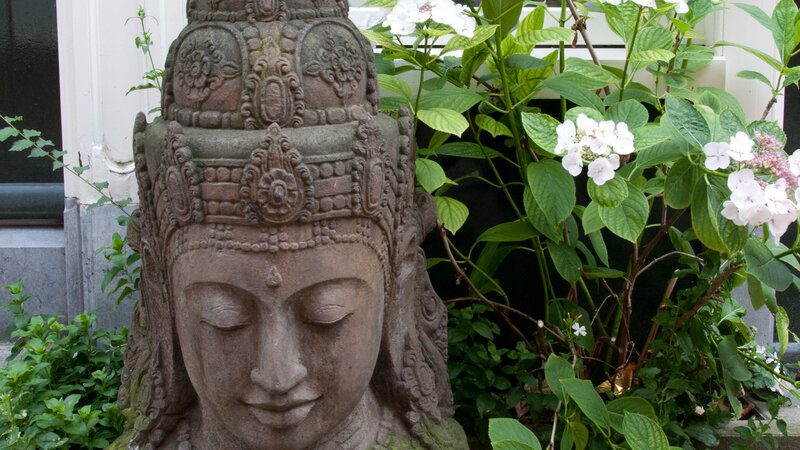 Stone statue of deity in garden