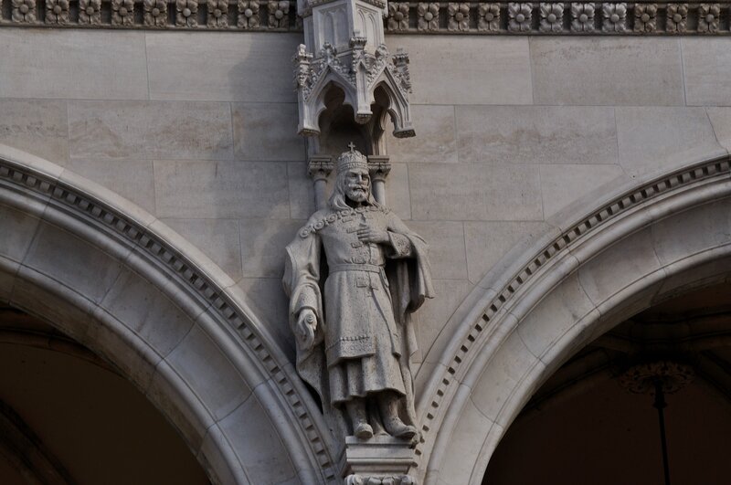stone statue of king on building