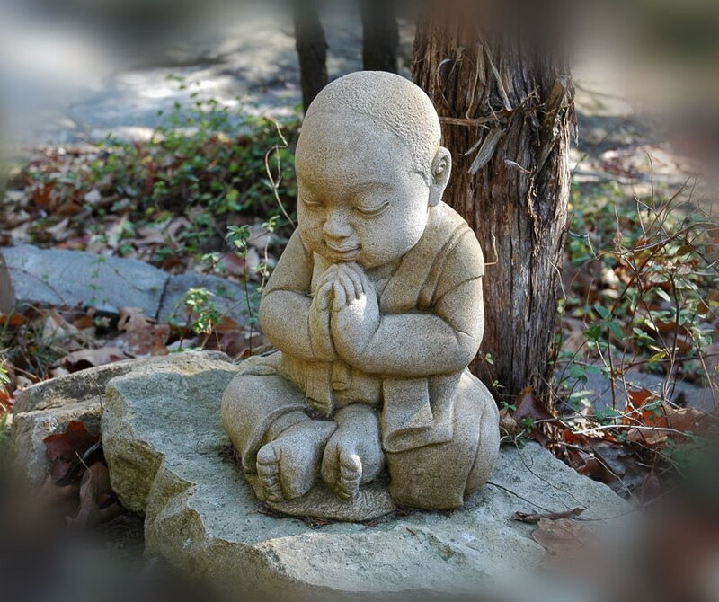 stone statue of praying child