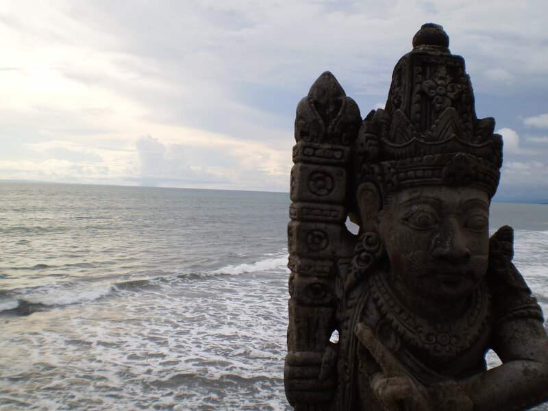 Stone statue overlooking the ocean
