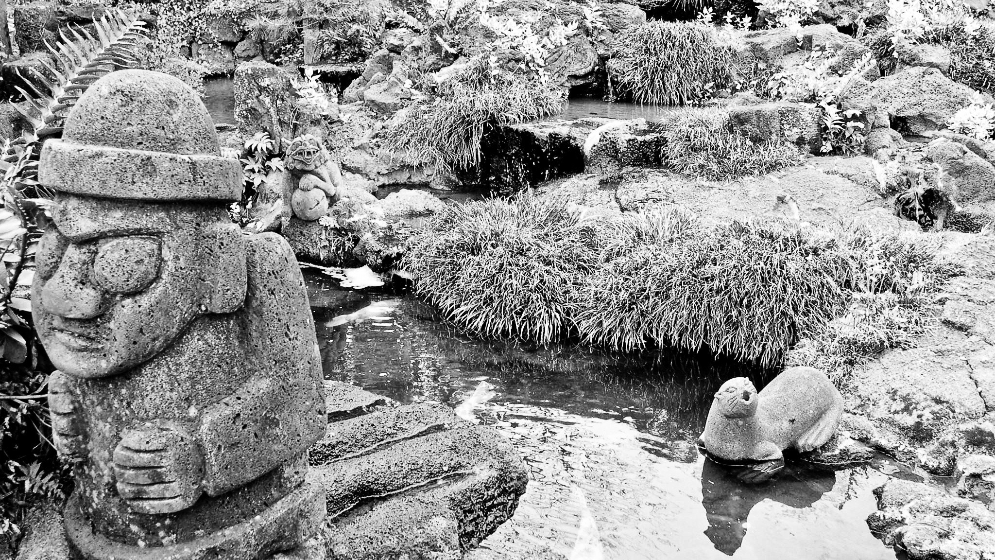 Stone statues in a garden pond