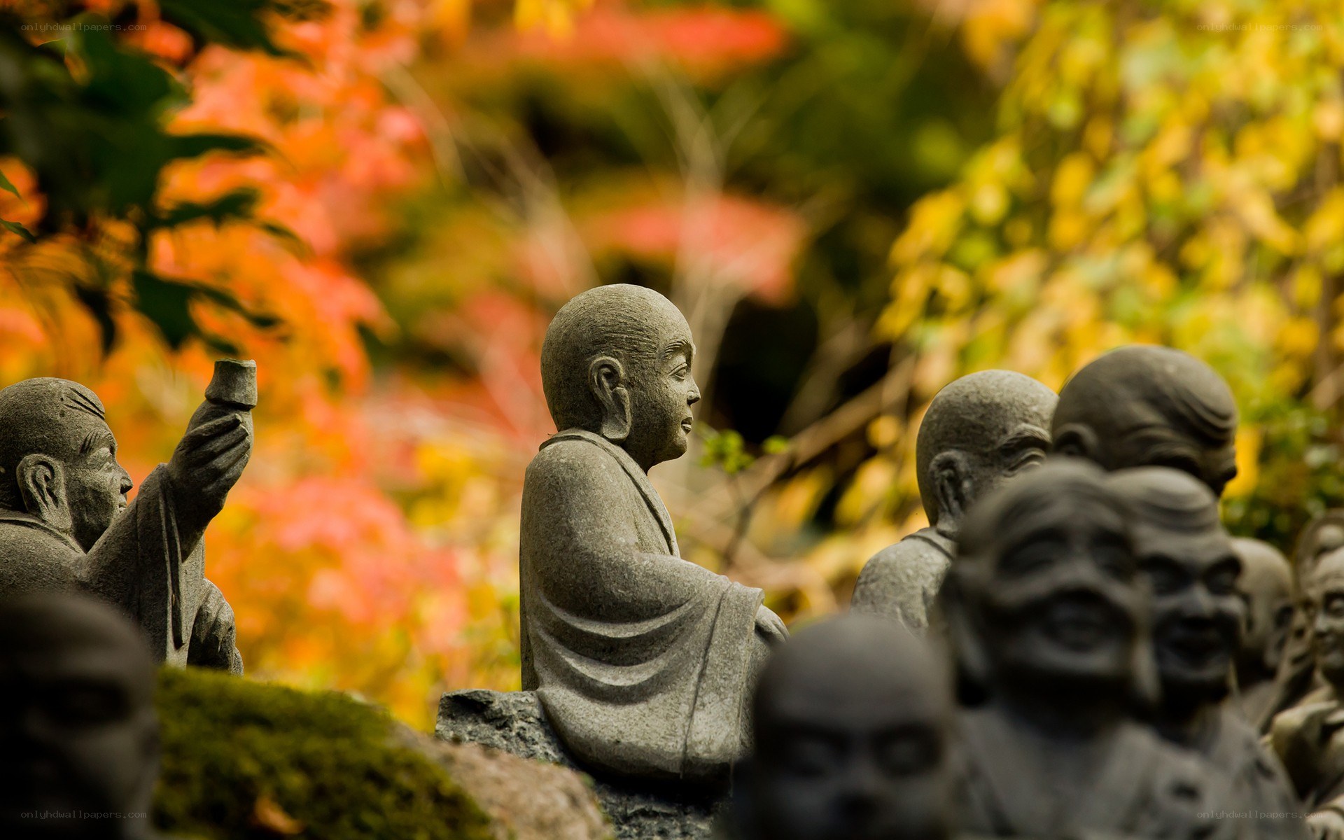 Stone statues in autumn garden