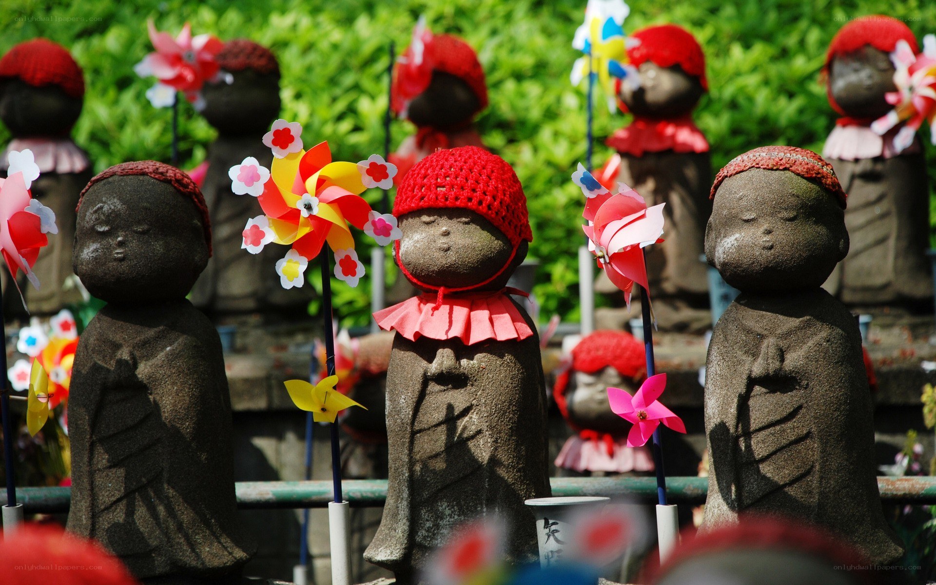 Stone statues with colorful hats
