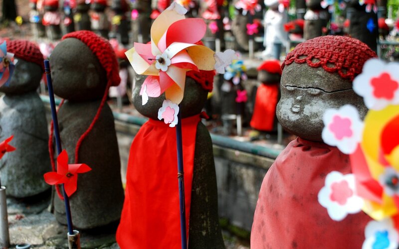 Stone statues with windmills