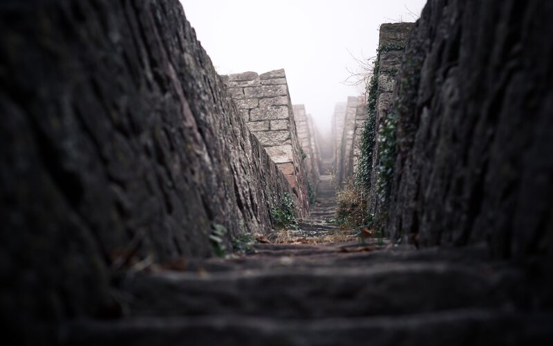 Stone steps in a foggy alley