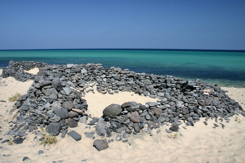 Stone Structures on Beach — Blue