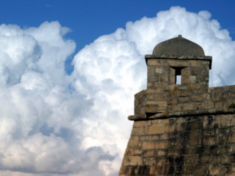 Stone tower against cloudy sky