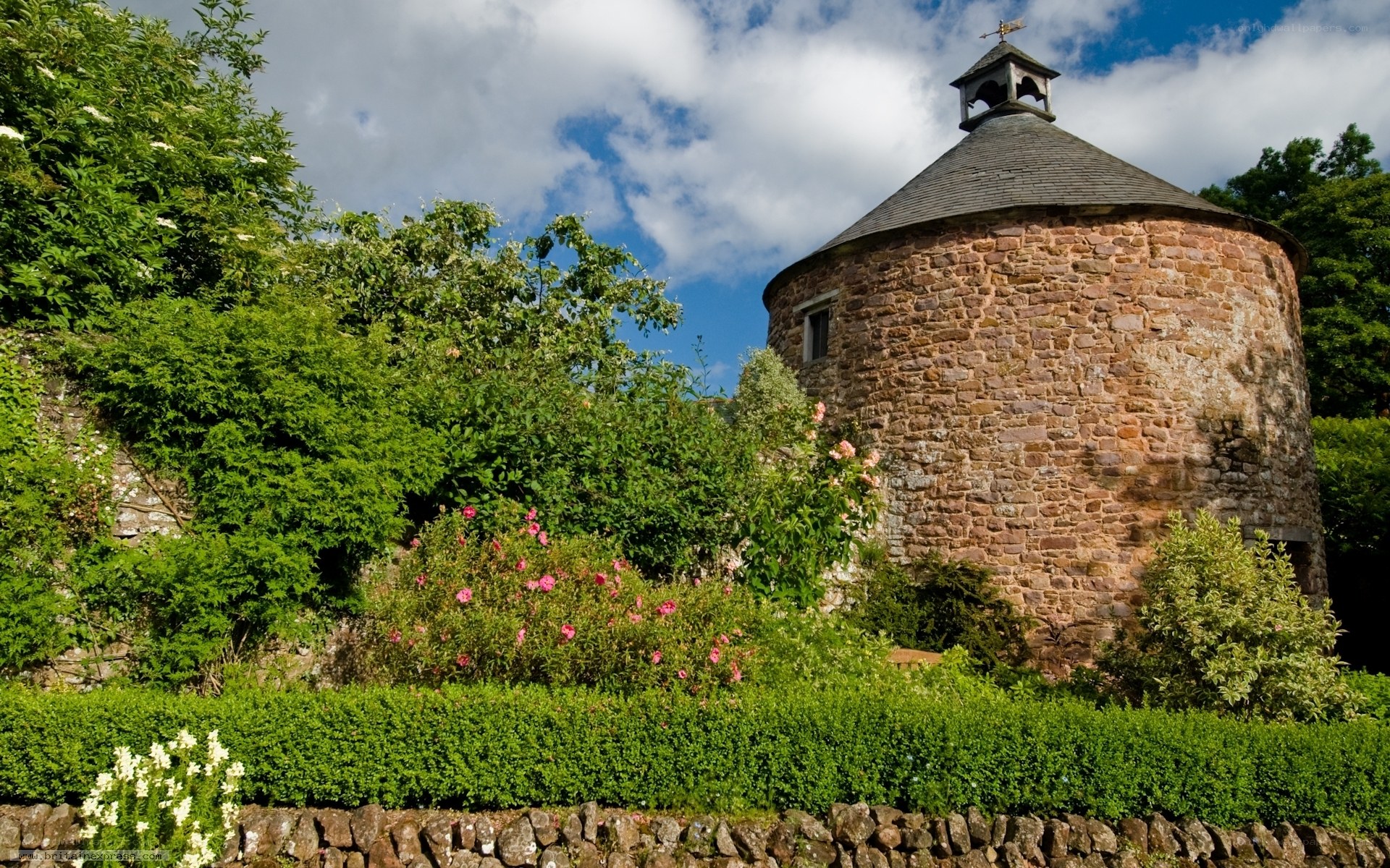 Stone tower in a lush garden