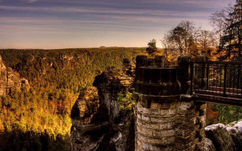 Stone tower overlooks forest canyon