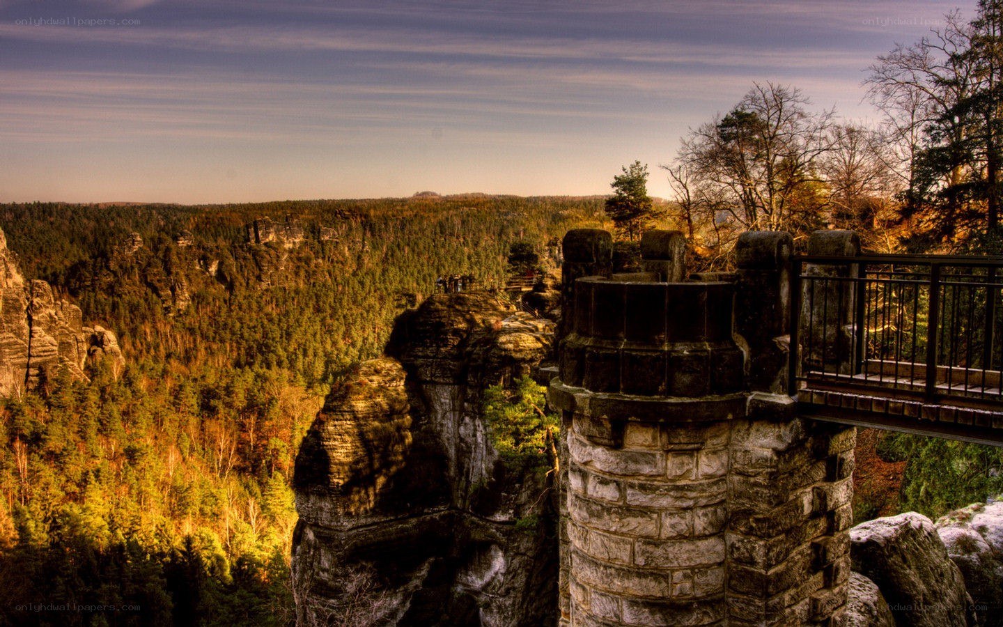 Stone tower overlooks forest canyon