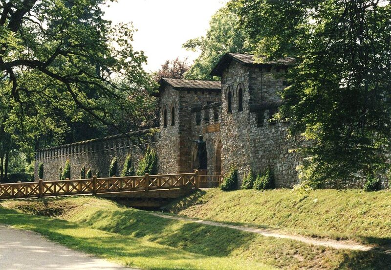 Stone wall and wooden bridge in park