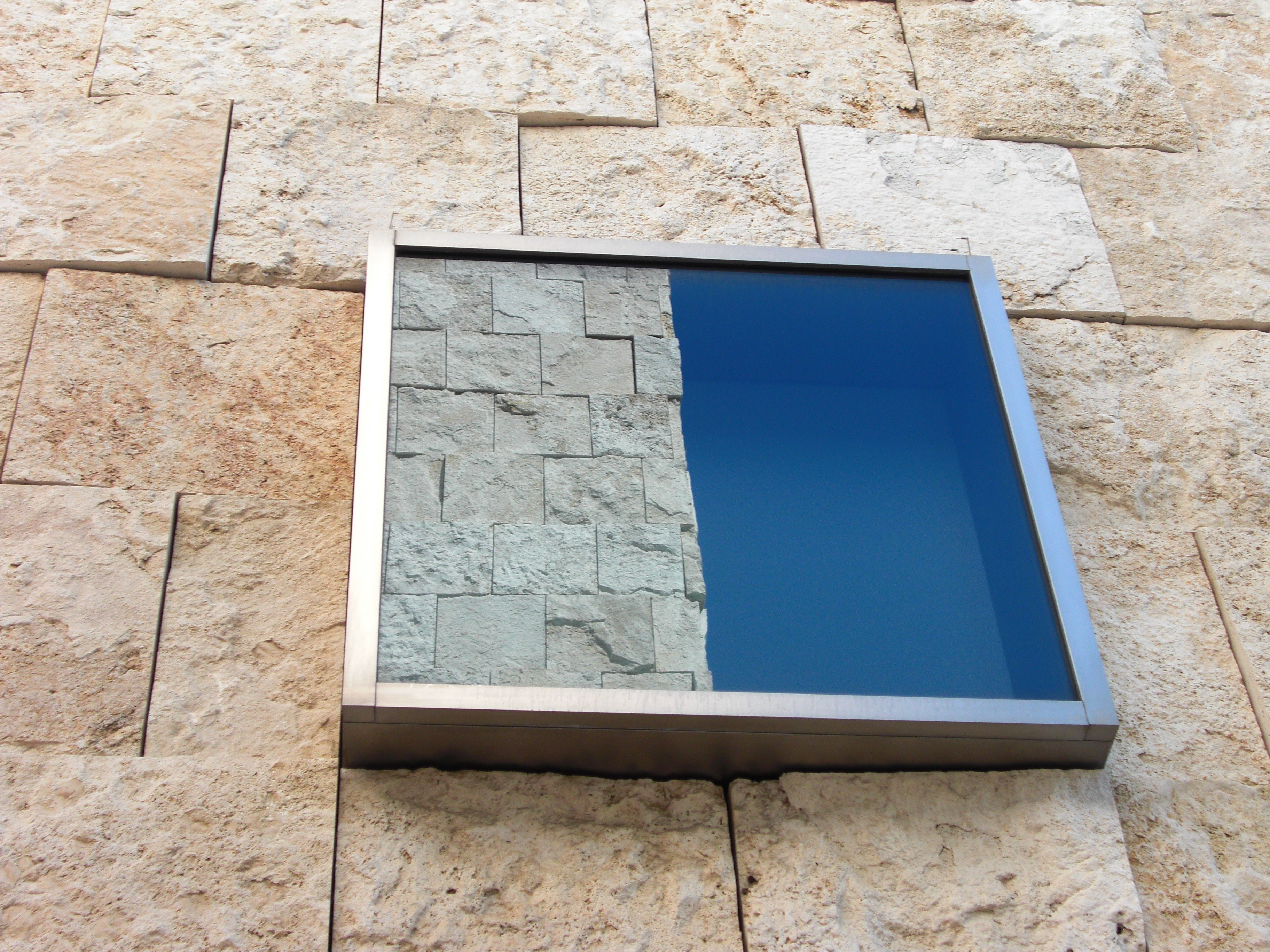 Stone wall with blue glass panel