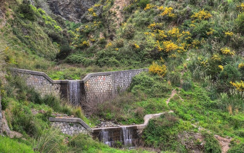Stone waterfall in a green valley