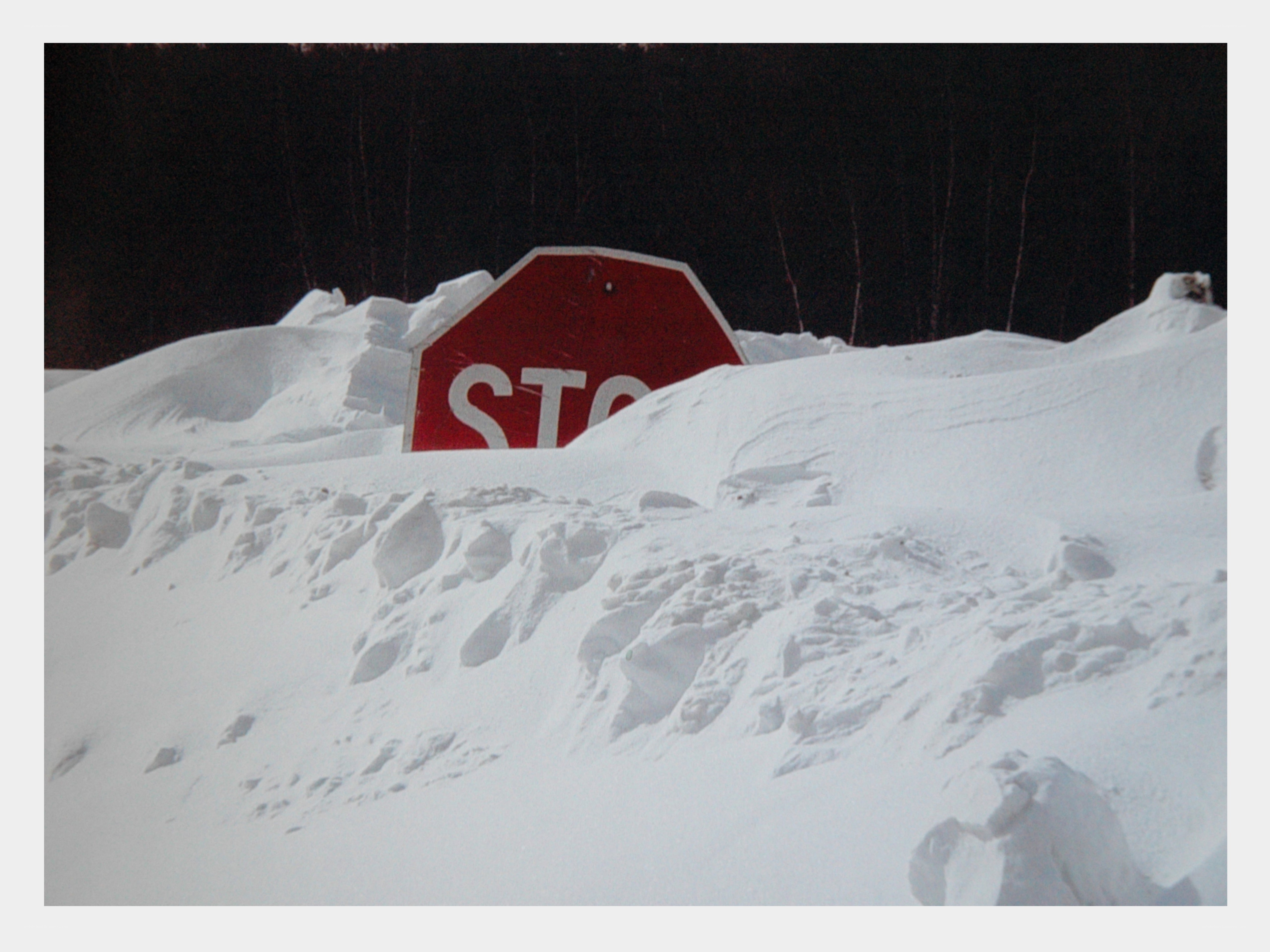 Stop sign buried in snow