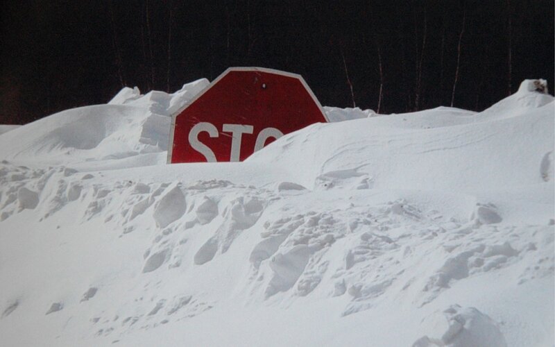 Stop sign buried in snow
