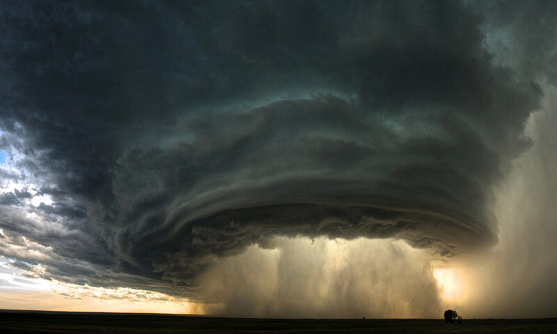 Storm cloud over open field