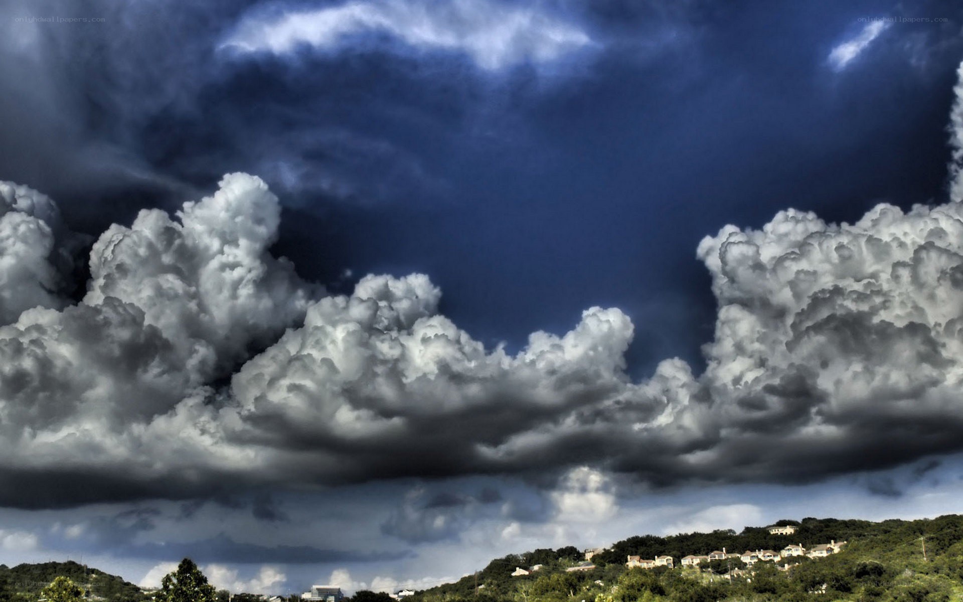 Storm clouds over a hillside town
