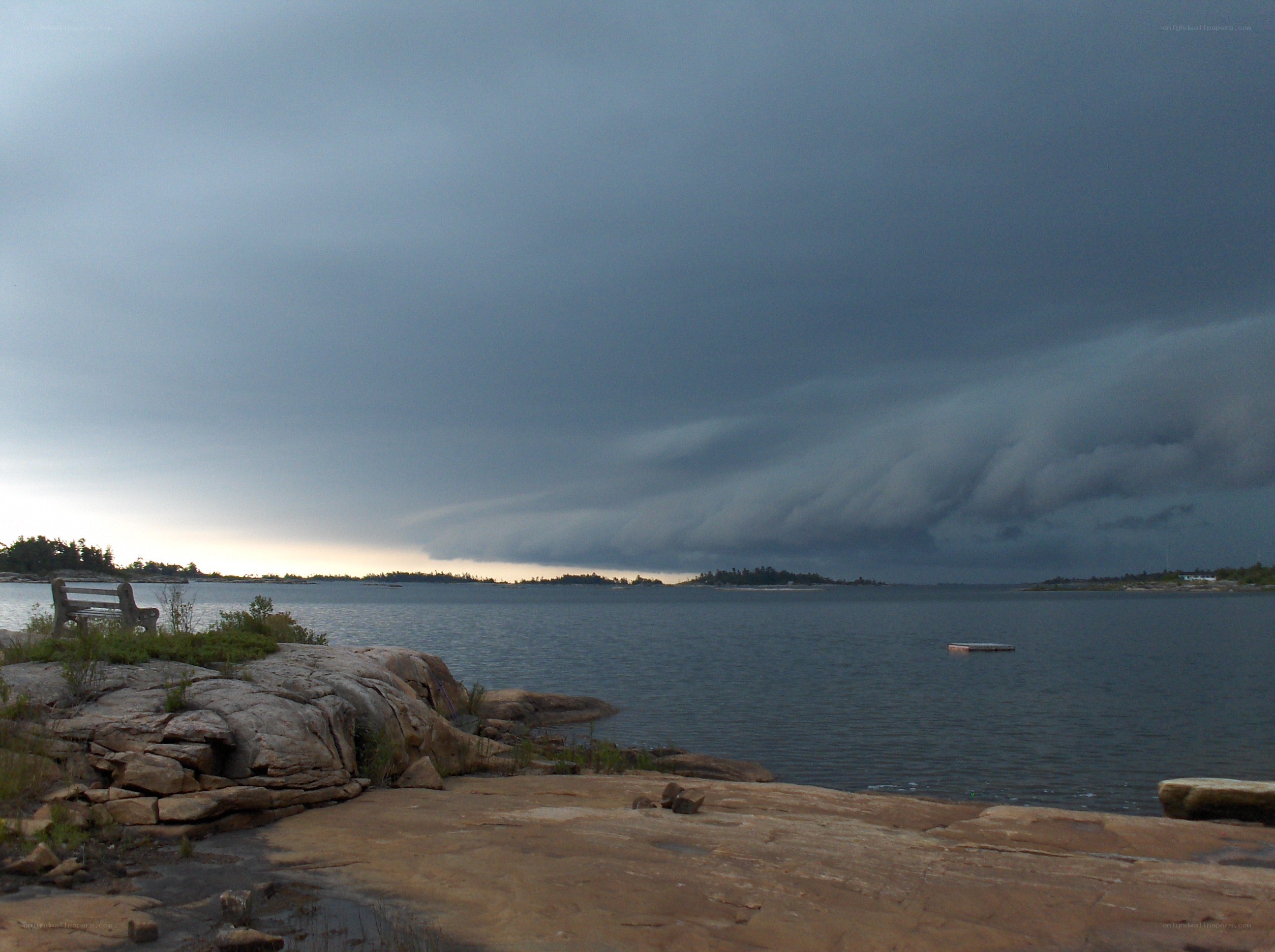 Storm clouds over a rocky shoreline