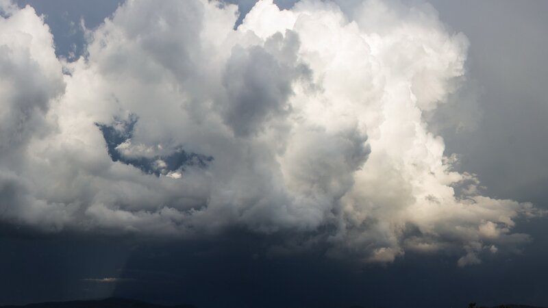 Storm clouds over dark landscape