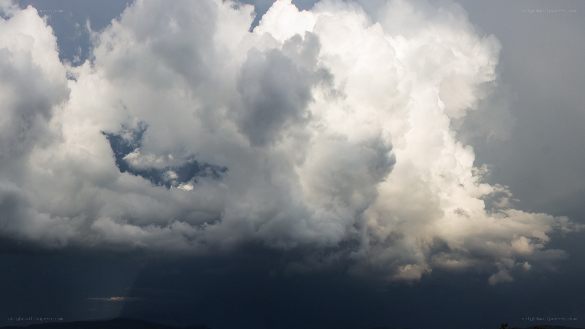 Storm clouds over dark landscape