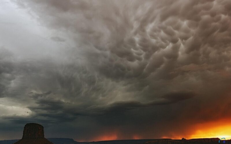 Storm clouds over desert butte